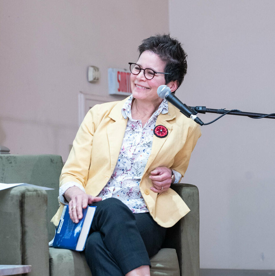 Ann-Marie MacDonald on a literary panel, smiling